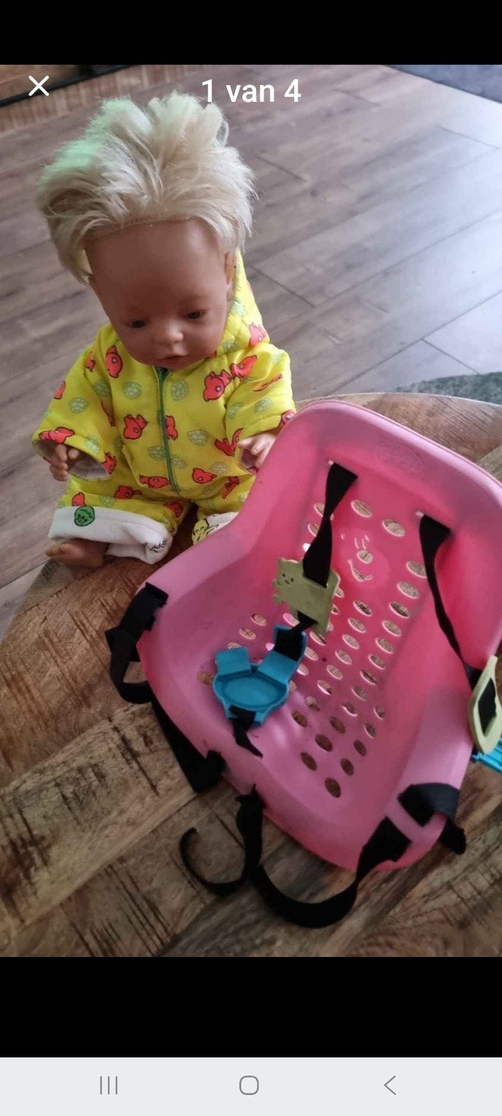 Babypop met roze fietsstoeltje, Ophalen