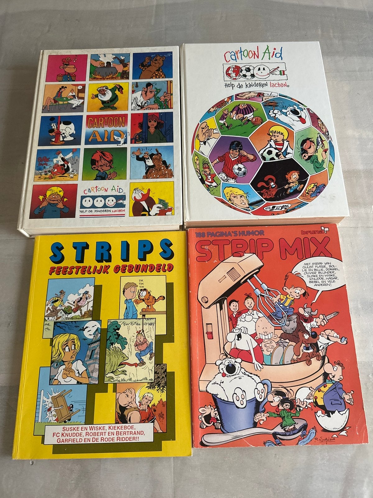 4 dikkestripboeken: Cartoon Aid, Strips Feestelijk Gebundeld, Meerdere stripboeken, Ophalen of Verzenden, Gelezen
