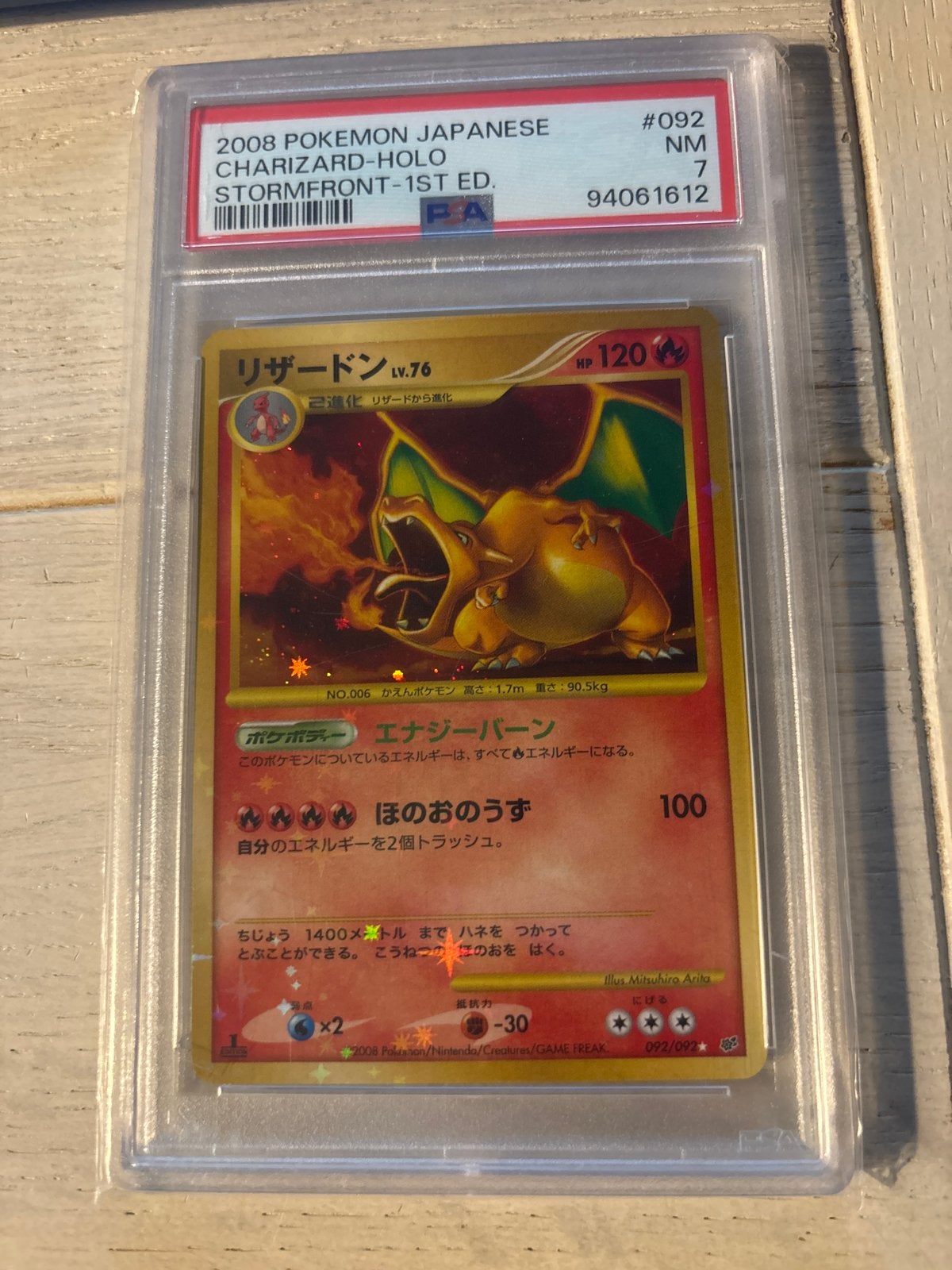 2008 Japanse Charizard Holo Stormfront 1st Ed. PSA 7, Ophalen of Verzenden, Zo goed als nieuw, Losse kaart