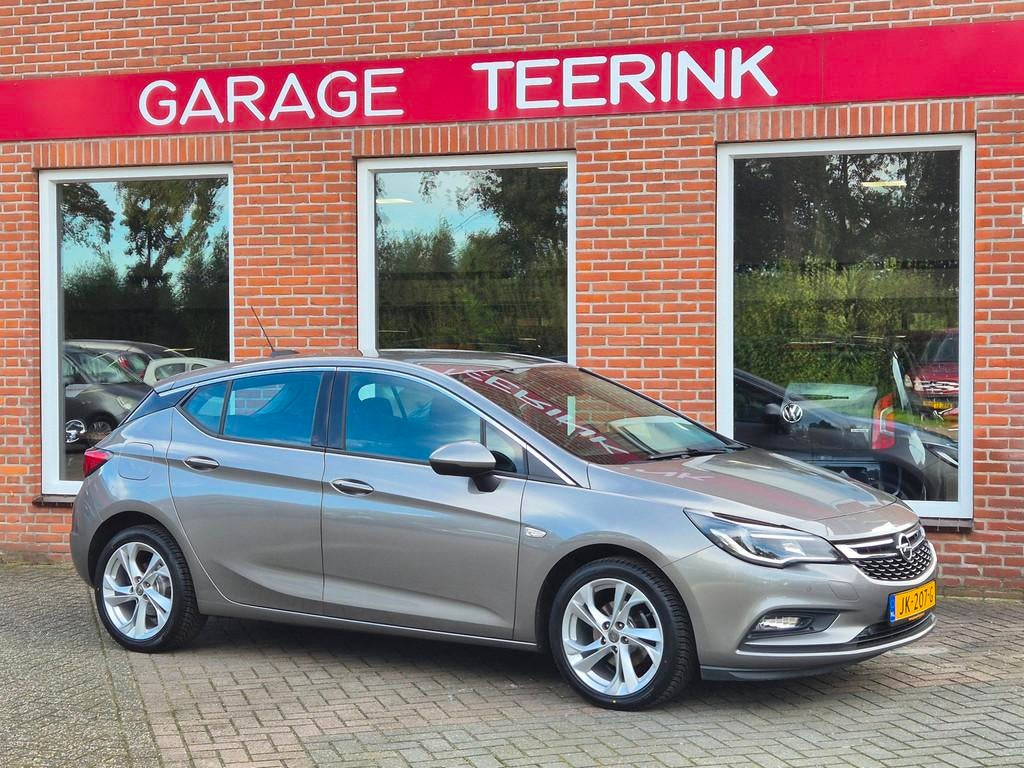 Opel Astra 1.0 Innovation 105PK 5drs clima, cruise, navi, pd, Auto's, Opel, Gebruikt, Euro 6, Bruin, 23 km/l
