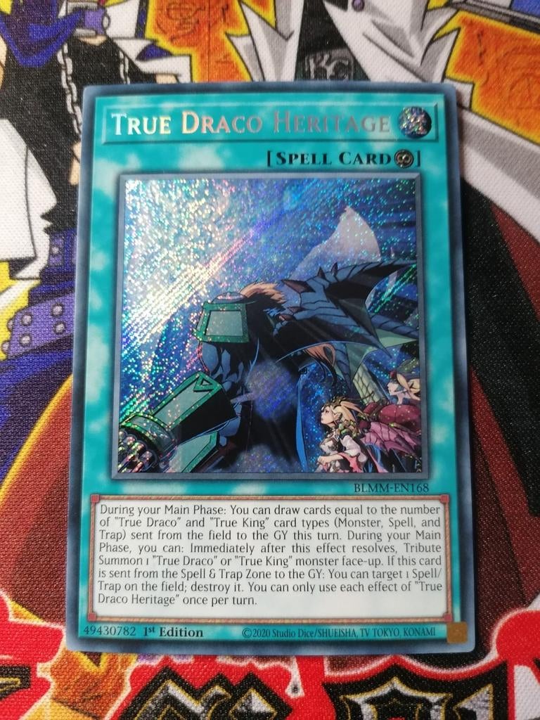 True Draco Heritage - Secret Rare BLMM - Yu-Gi-Oh, Hobby en Vrije tijd, Ophalen of Verzenden, Zo goed als nieuw, Foil