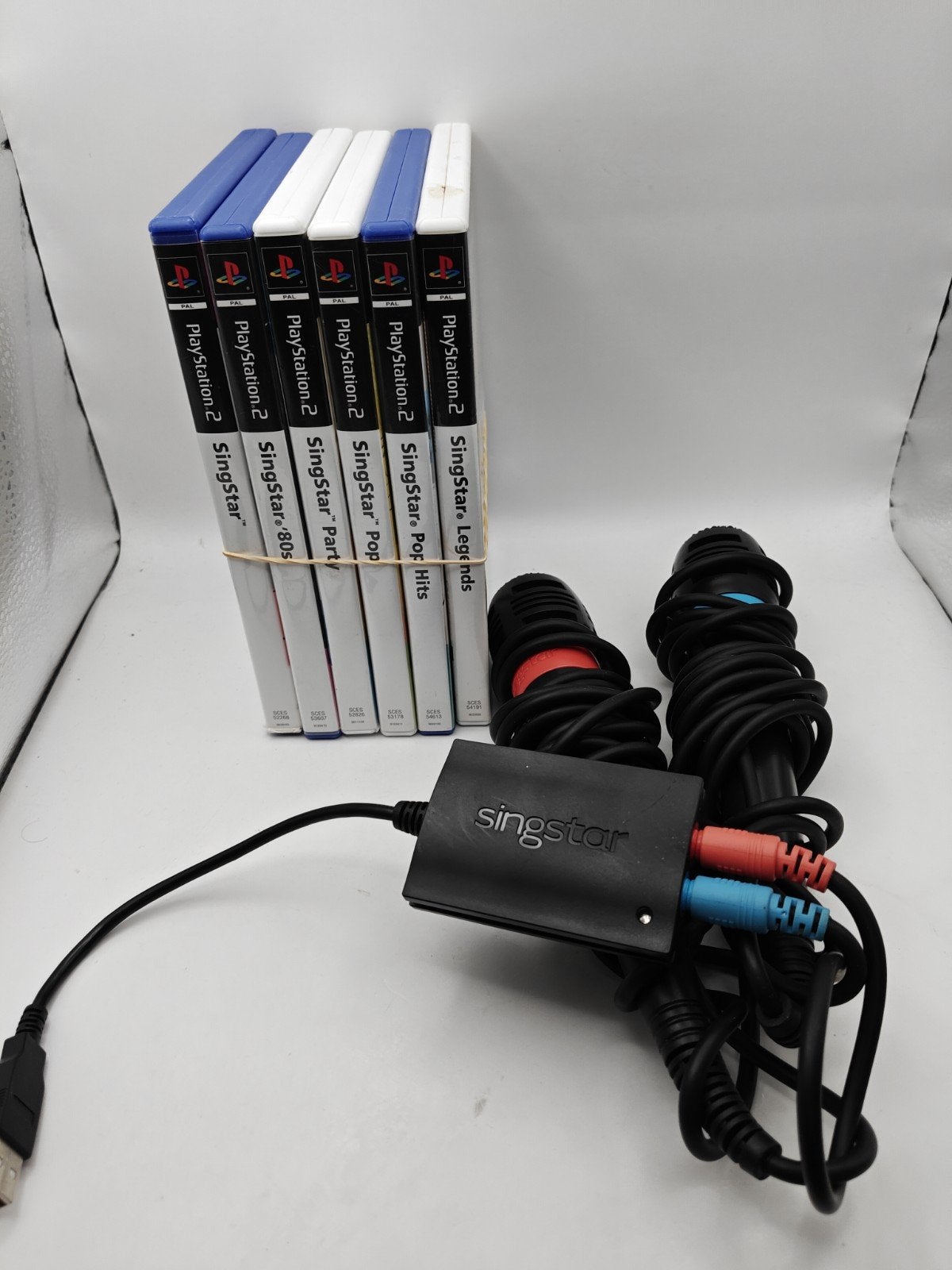 SingStar PlayStation 2 bundel met 6 spellen en microfoons, Muziek, Gebruikt, Sony Interactive Entertainment Europe Ltd, 10 Great Marlborough Street, London, W1F 7LP, UK