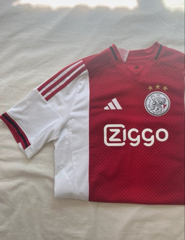 Ajax Thuisshirt 2025/2026 - Maat 15-16Y/176, Kleding | Dames, Overige typen, Ophalen of Verzenden, Ajax, Maat 36 (S)