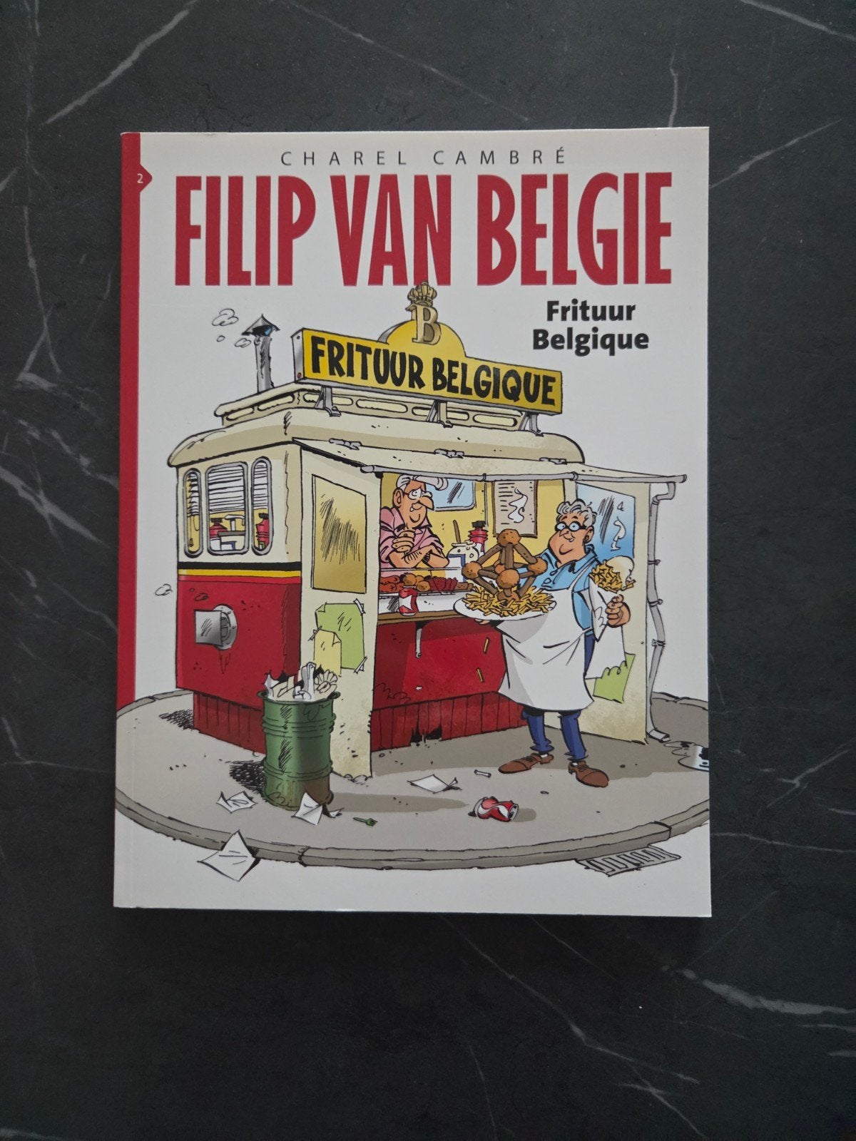 Filip van België - Frituur Belgique - Charel Cambré, Eén stripboek, Ophalen of Verzenden, Zo goed als nieuw, Charel Cambré