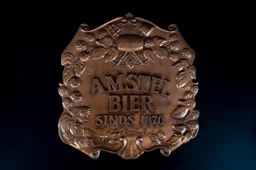 Amstel bordje koperkleurig., Ophalen of Verzenden, Gebruikt, Reclamebord, Plaat of Schild, Amstel