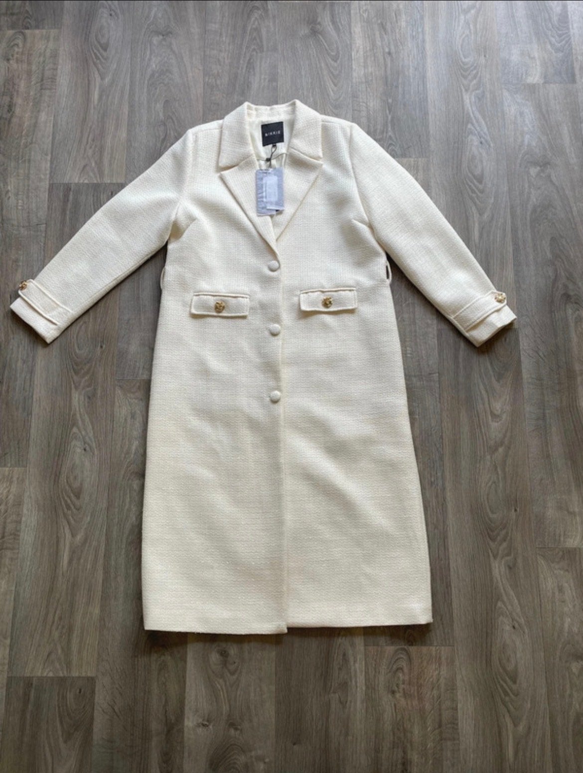 Nikkie lange jas maat 42, nieuw met kaartjes, Kleding | Dames, Jassen | Winter, Ophalen of Verzenden, Nieuw, Maat 42/44 (L), Beige