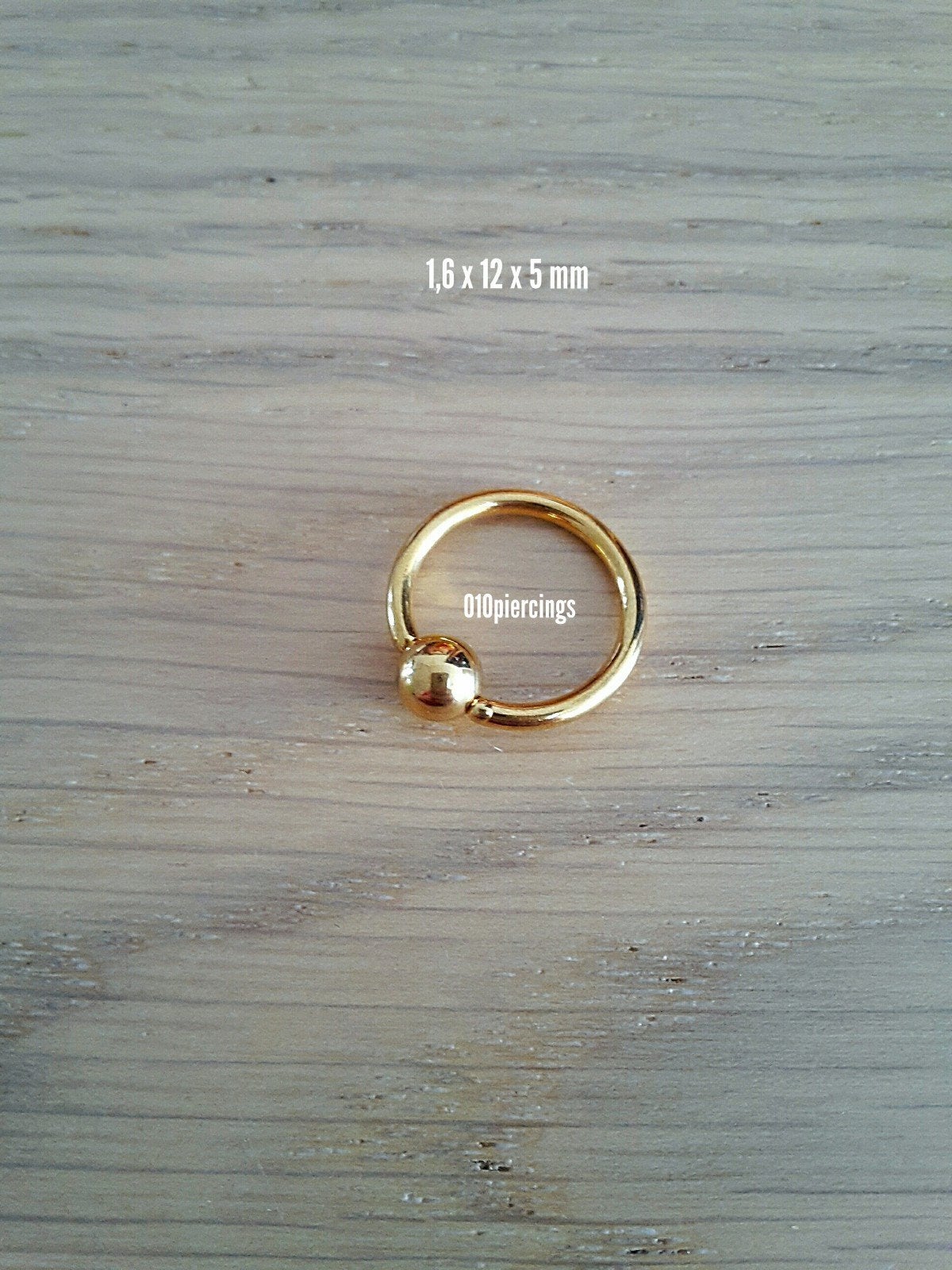 Nieuwe ball closure ring, goud kleur. Staal., Ophalen of Verzenden, Zo goed als nieuw, Staal, Oor- of Traguspiercing
