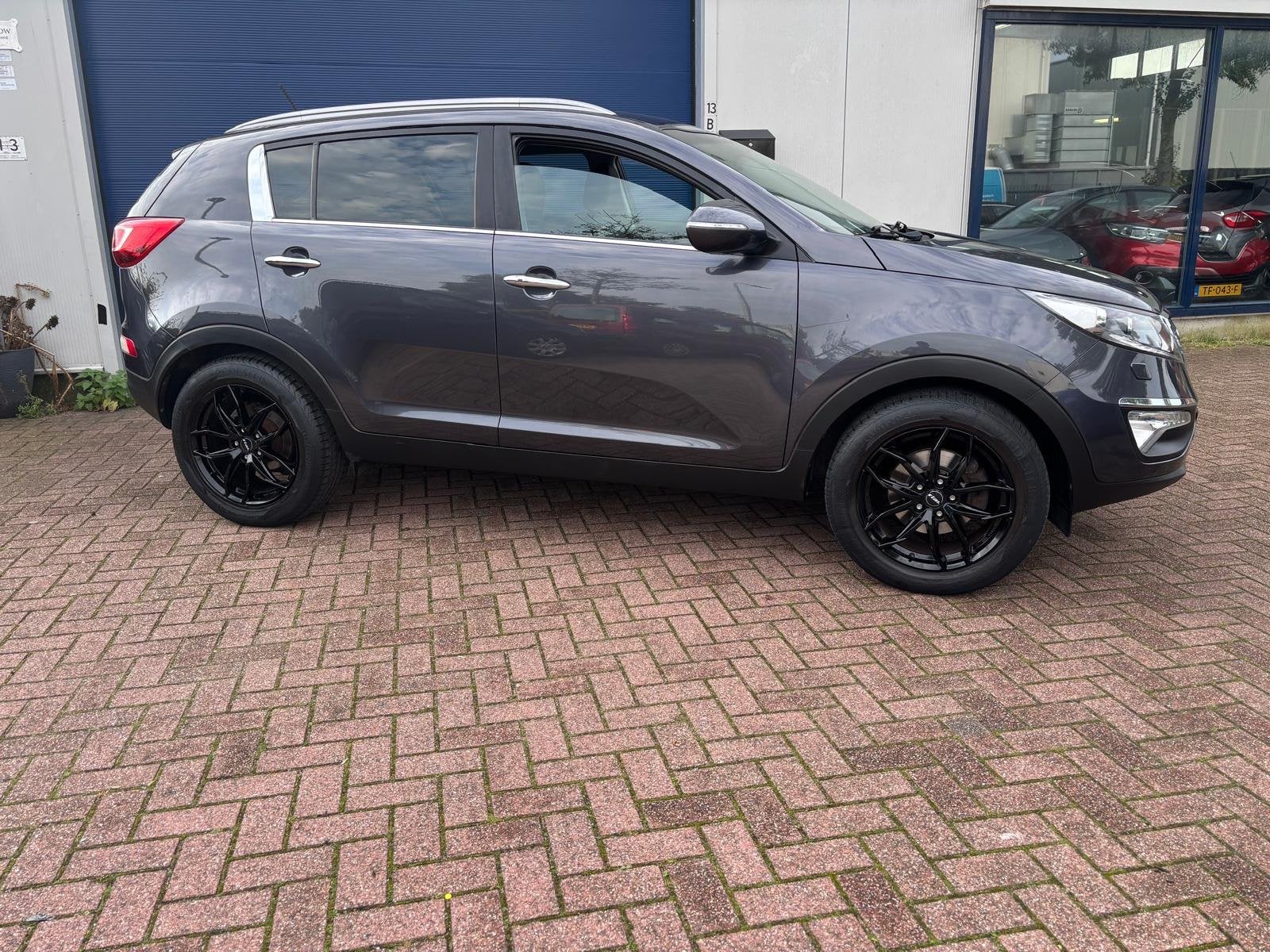 Kia Sportage 2.0 X-clusive INCL NWE APK!, Auto's, Gebruikt, Zwart, 4 cilinders, 163 pk