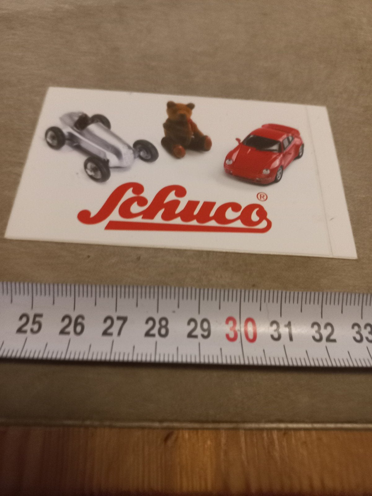 Schuco reclamesticker met miniatuurauto's en teddybeer, Ophalen of Verzenden, Gebruikt, Overige typen