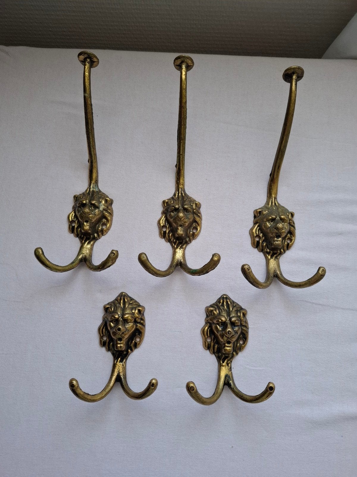 5 stuks oude koperen kapstokhaken leeuw, Gebruikt, Wandhaken, Ophalen of Verzenden, Minder dan 100 cm