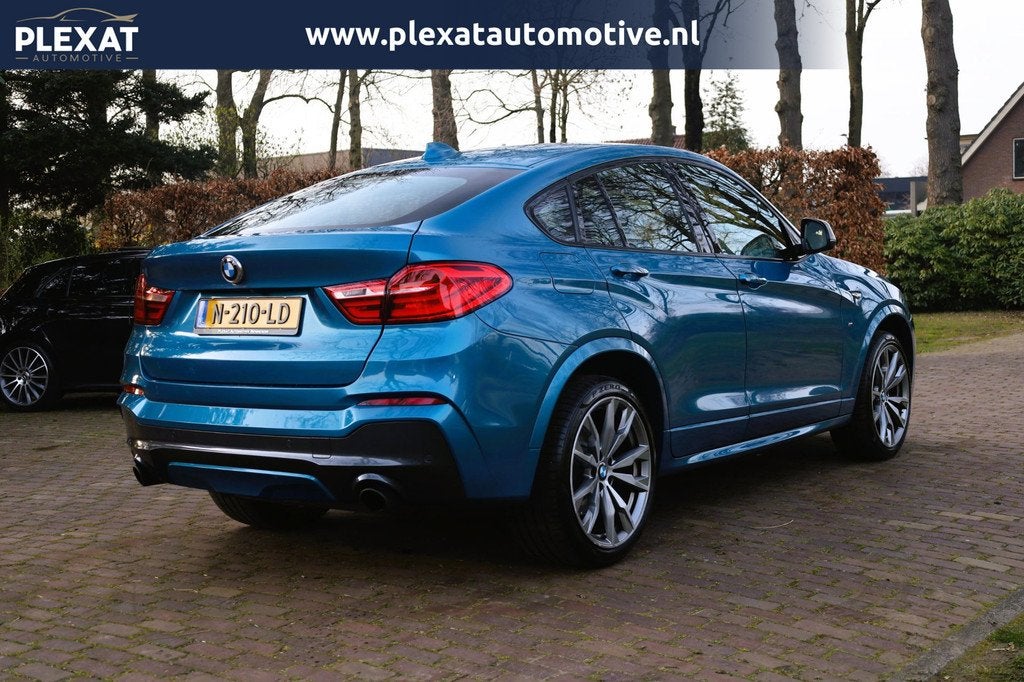 BMW X4 M40i Centennial High Executive Aut. | Dealeronderhoud, Auto's, BMW, Automaat, Gebruikt, 2000 kg, Blauw