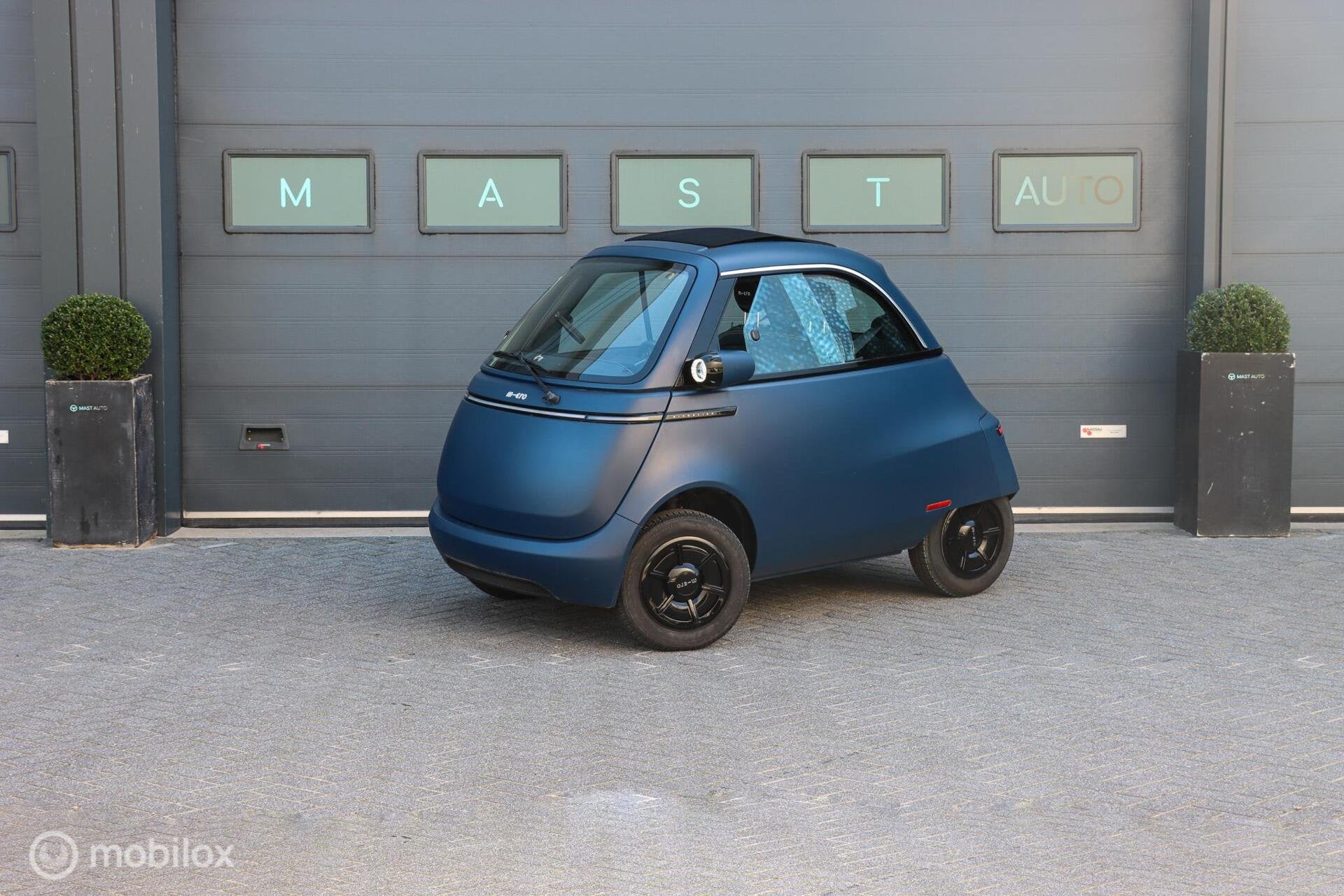 Microlino Competizione 10.5 kWh L7 177 Km. 90 KM/U|BTW|FOLDI, Auto's, Dealer onderhouden, Gebruikt, Zwart, Overige carrosserieën