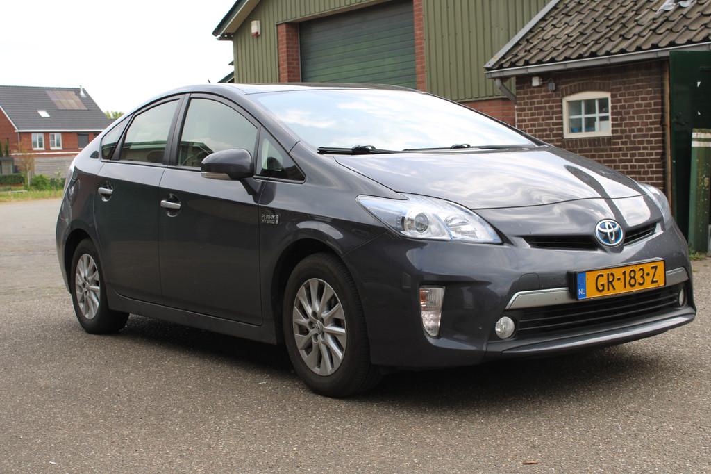 Toyota Prius 1.8 Plug-in Aspiration HUD CRUISE NAVI CAMERA P, Auto's, Toyota, Stof, Gebruikt, Blauw, Stoelverwarming