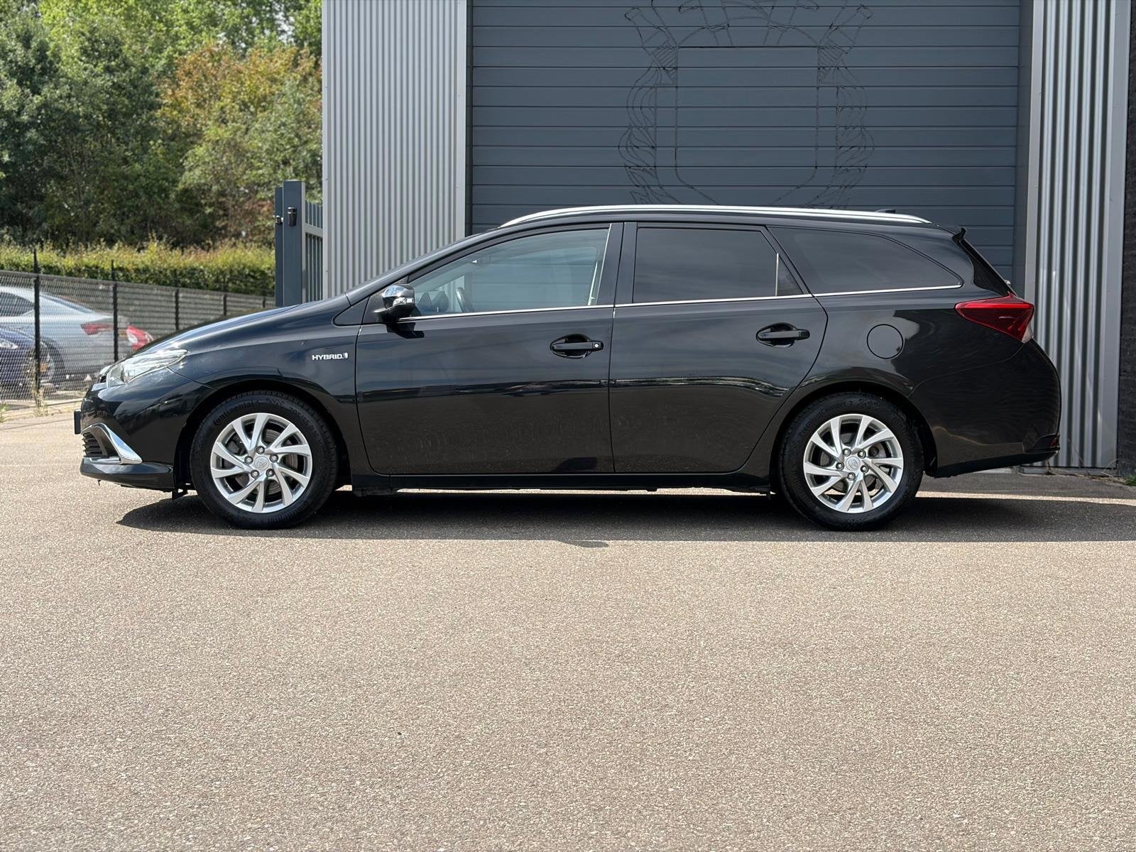 Toyota Auris Touring Sports 1.8 Hybrid Executive Half Leer|C, 28 km/l, Gebruikt, Leder en Stof, Zwart