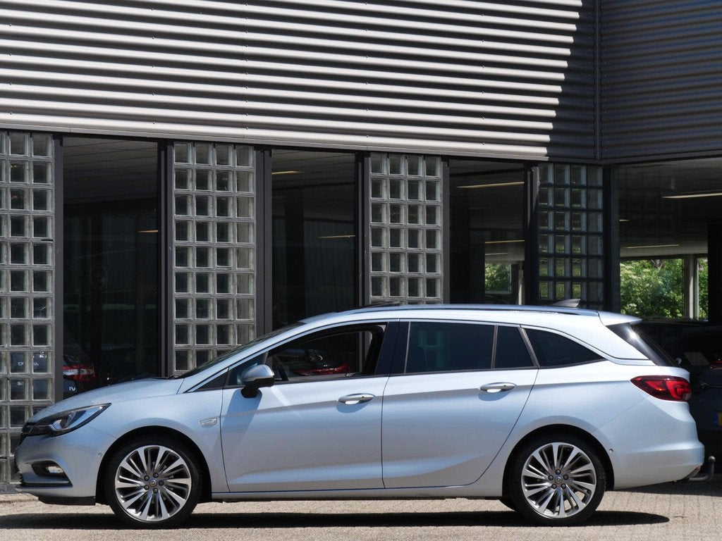 Opel Astra ST 1.4T INNOVATION/ SCHUIFDAK/ TREKHAAK/ BLIS/ CA, Auto's, Parkeersensor, Stof, Gebruikt, 4 cilinders