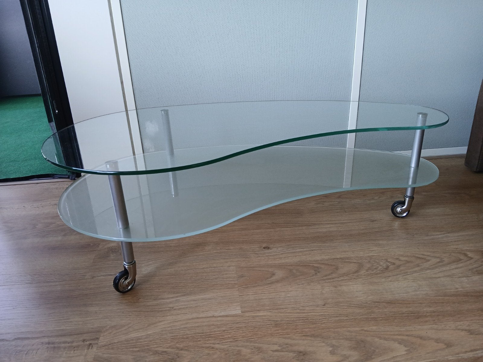 Glazen salontafel met twee lagen. Op 3 wieltjes., Ophalen, 100 tot 150 cm, 50 tot 100 cm, Glas