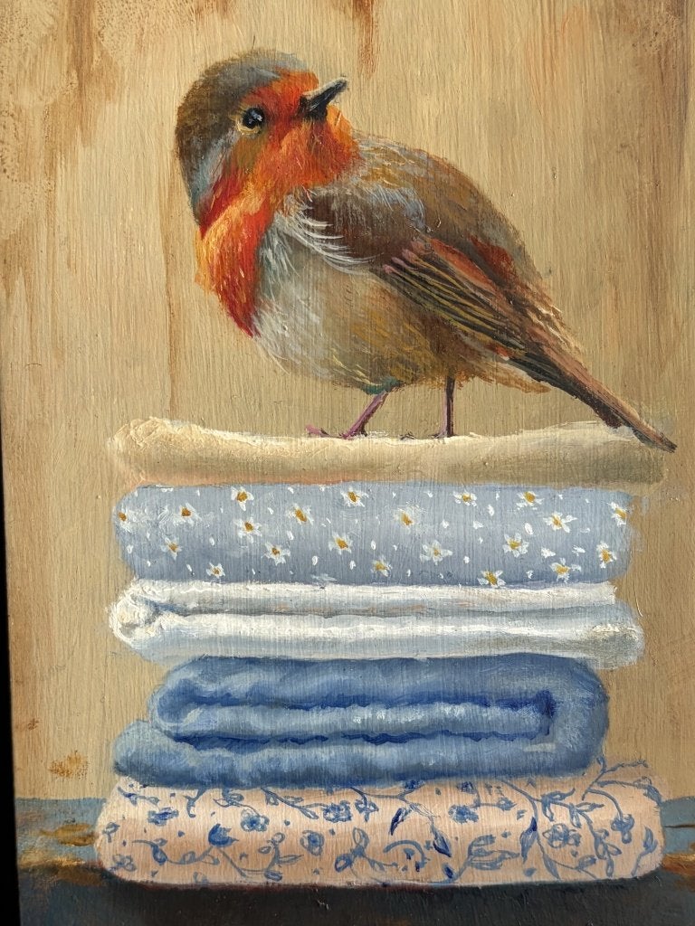 Marian van der Sanden, roodborstje op stapel linnengoed, Ophalen