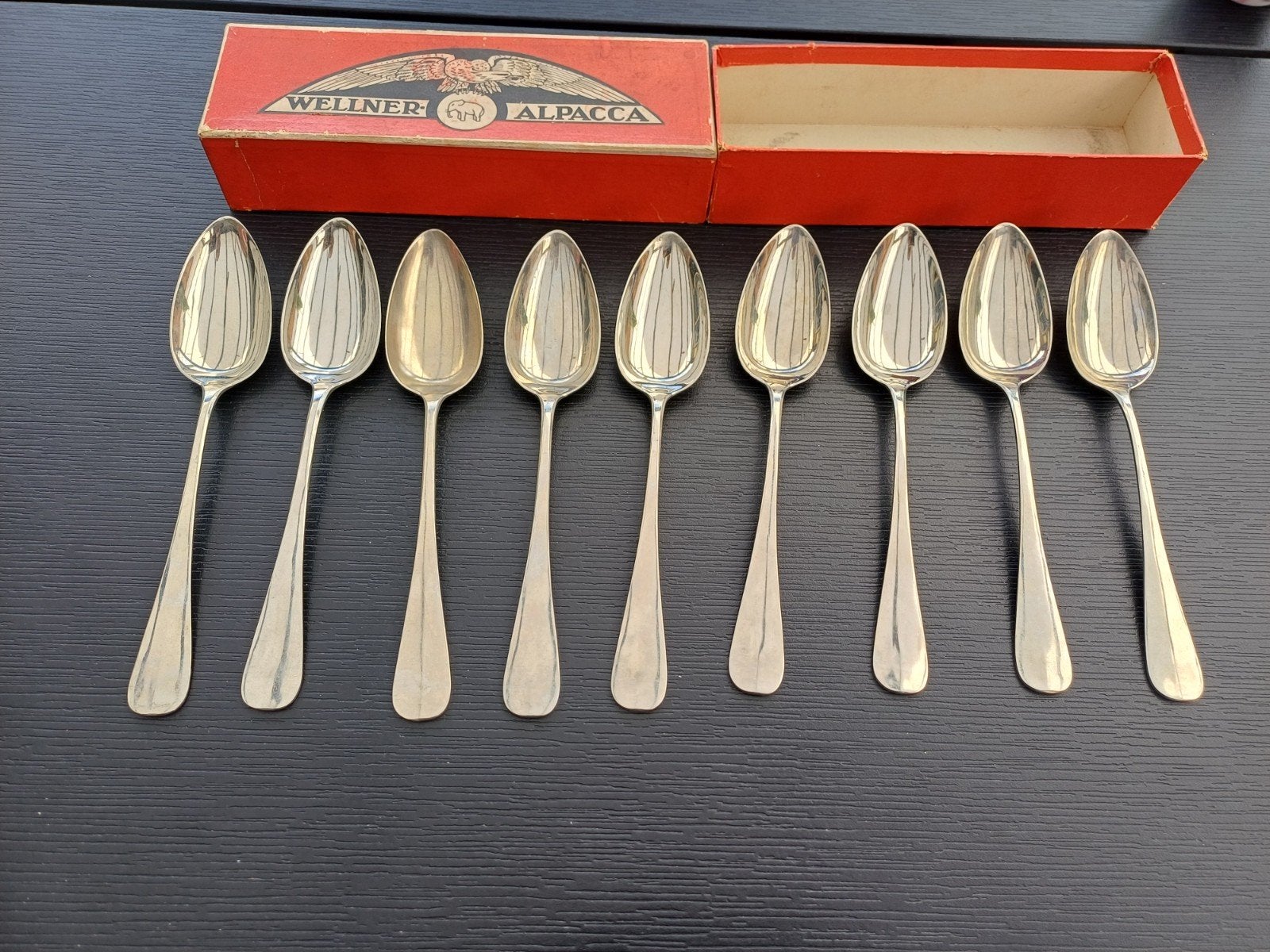 Set van 9 Wellner Alpaca lepels in originele doos, Antiek en Kunst, Antiek | Bestek, Ophalen