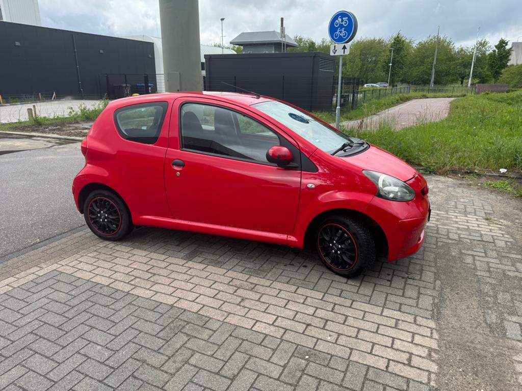 CARPLAY | Toyota Aygo 1.0 12V Vvt-i 3DRS MMT 2006 Rood, Auto's, Toyota, Voorwielaandrijving, Stof, Zwart, 4 stoelen