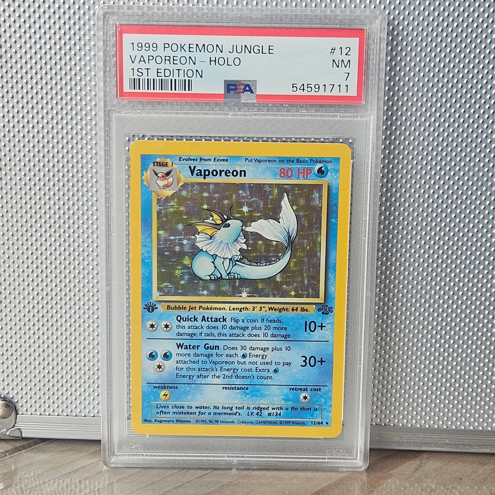 Vaporeon Holo 1st Edition PSA 7 - 1999 Pokemon Jungle, Ophalen of Verzenden, Gebruikt, Losse kaart