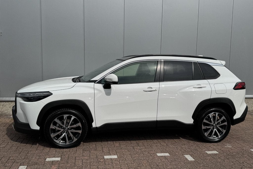 Toyota Corolla Cross 1.8 Hybrid Style Premium Pack II, Panor, Auto's, Gebruikt, 4 cilinders, Leder en Stof, Wit