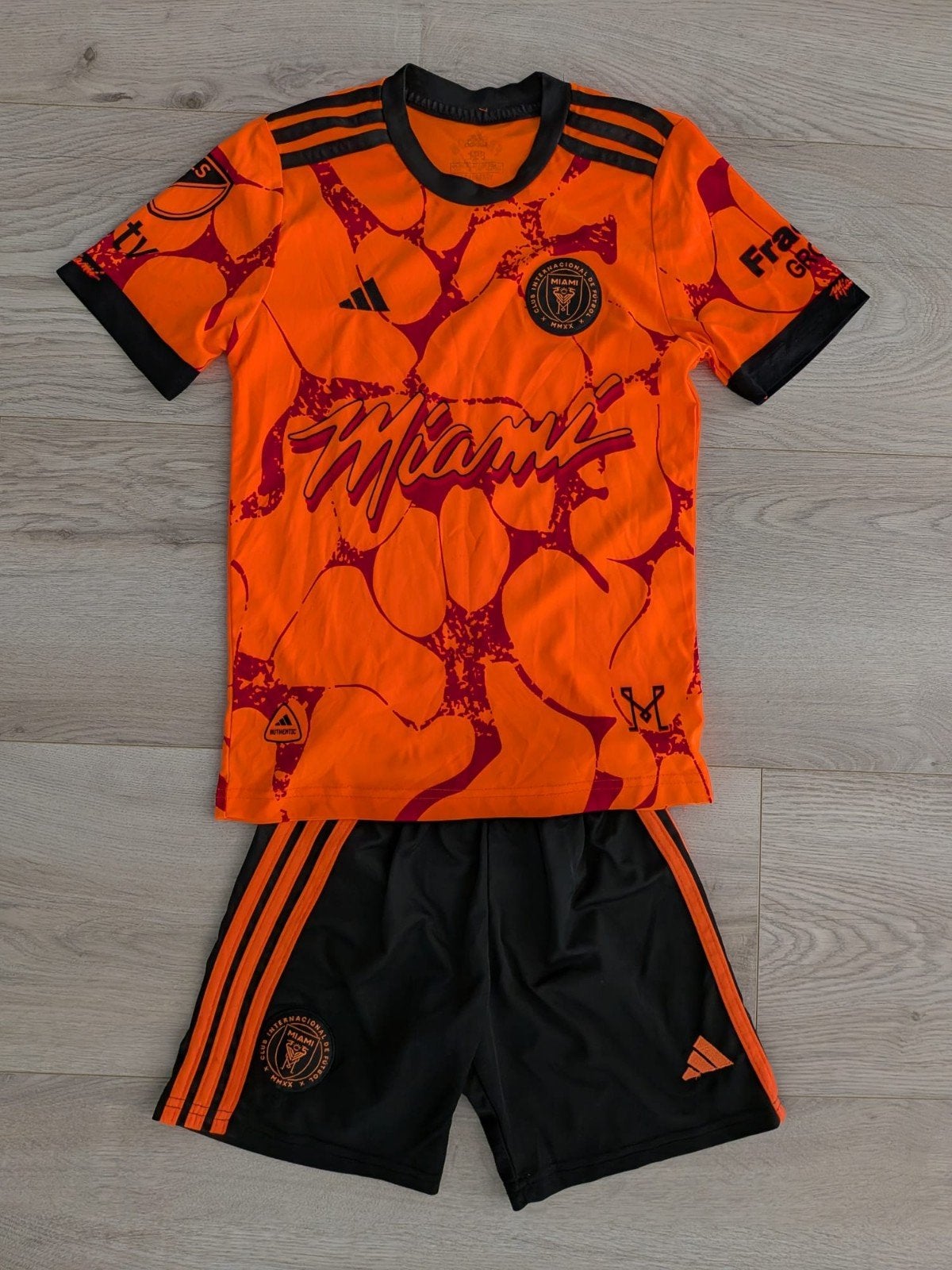 Inter Miami Messi voetbaltenue - Oranje/Zwart mt 128, Kinderen en Baby's, Kinderkleding | Overige, Ophalen of Verzenden, Zo goed als nieuw
