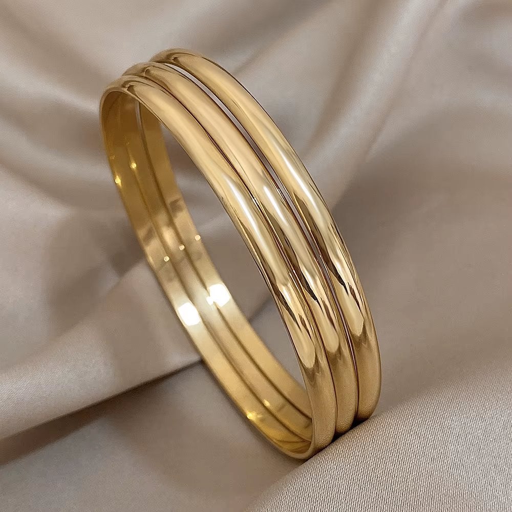 Drie Goudkleurige Dames Armbanden Set, Verzenden, Nieuw, Goud, Staal