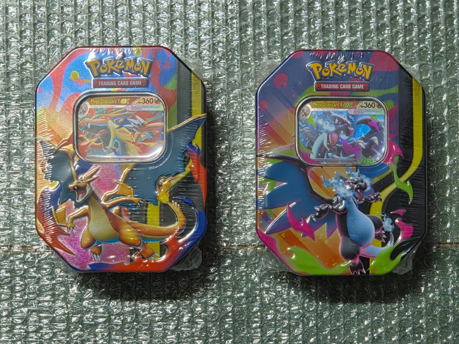 Pokemon Mega Charizard X en Y ex tins, Ophalen of Verzenden, Nieuw, Overige typen, Foil