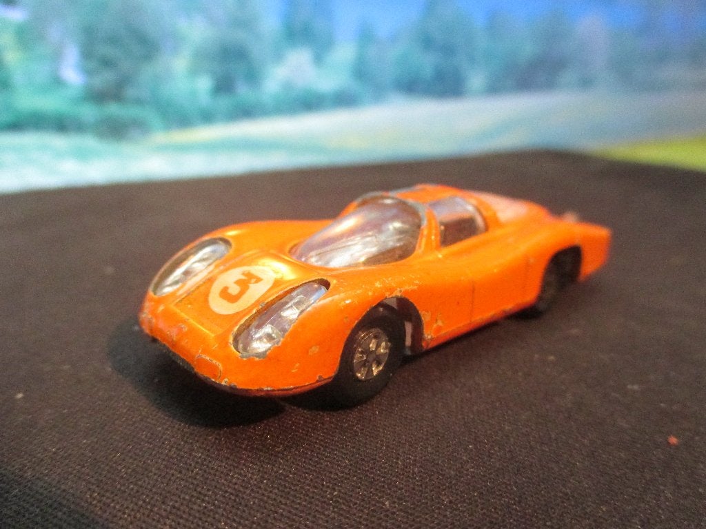 1:65 Porsche Le Mans - Majorette #232 oranje met wieldopjes, Hobby en Vrije tijd, Modelauto's | Overige schalen, Ophalen of Verzenden