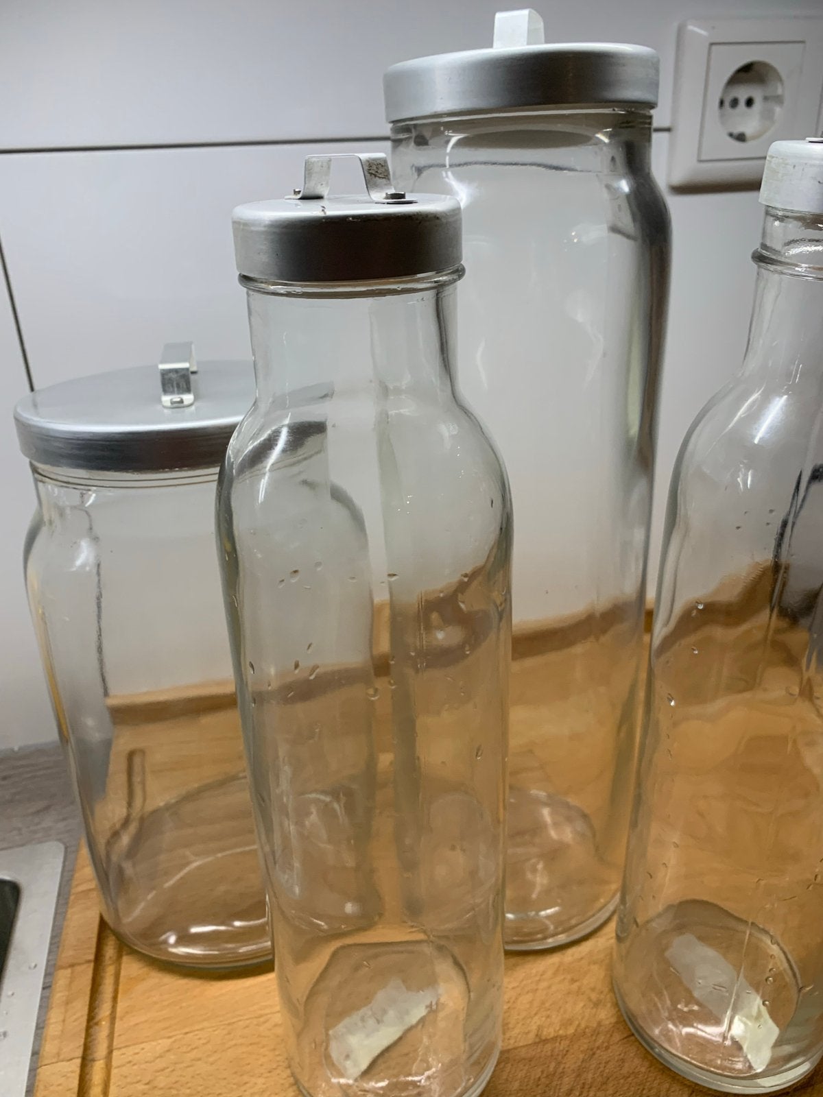 Set van 4 glazen flessen/potten met deksel, Huis en Inrichting, Woonaccessoires | Vazen, Ophalen, Gebruikt, Transparant, Met deksel