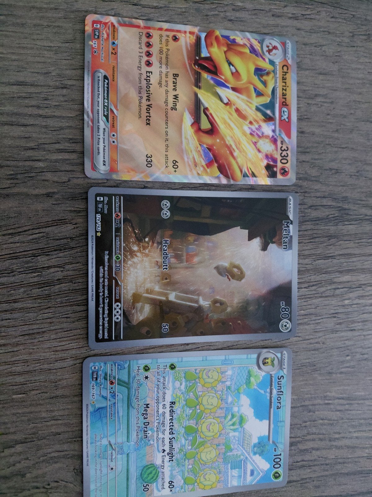 Pokémon kaarten: Charizard EX, Meltan, Sunflora, Hobby en Vrije tijd, Verzamelkaartspellen | Pokémon, Gebruikt, Meerdere kaarten
