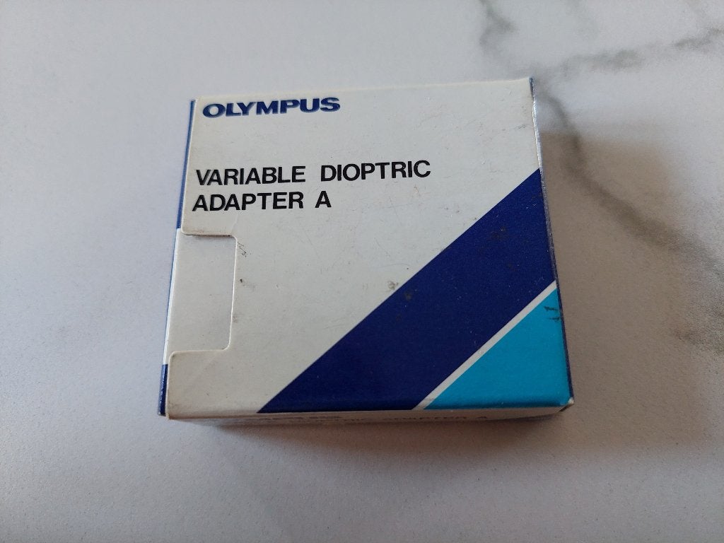 515 - Olympus Diop tric Adapter A - van -2 naar -4 - nieuw, Ophalen of Verzenden, 1980 tot heden, Fototoestel