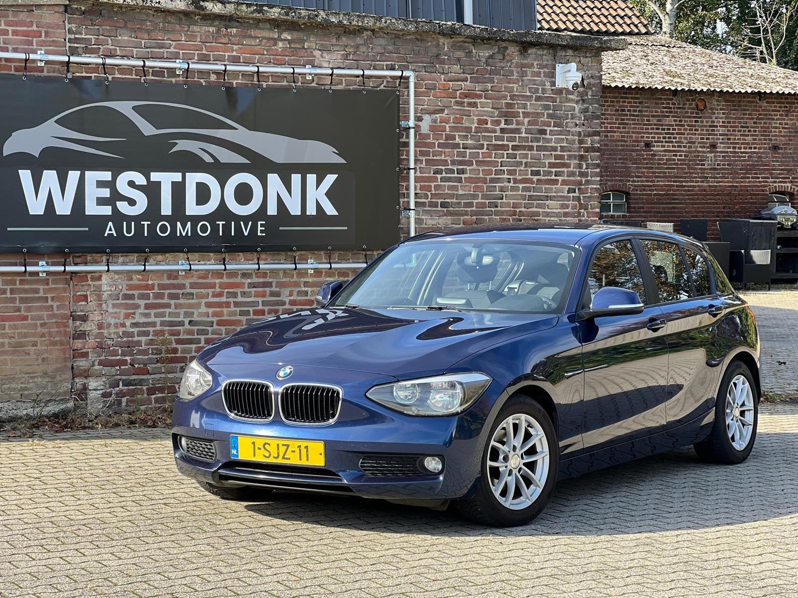 BMW 1-serie 114i EDE Business - Navi/Cruise/NAP, Auto's, 1-Serie, Gebruikt, Euro 6, Verwarmde buitenspiegels