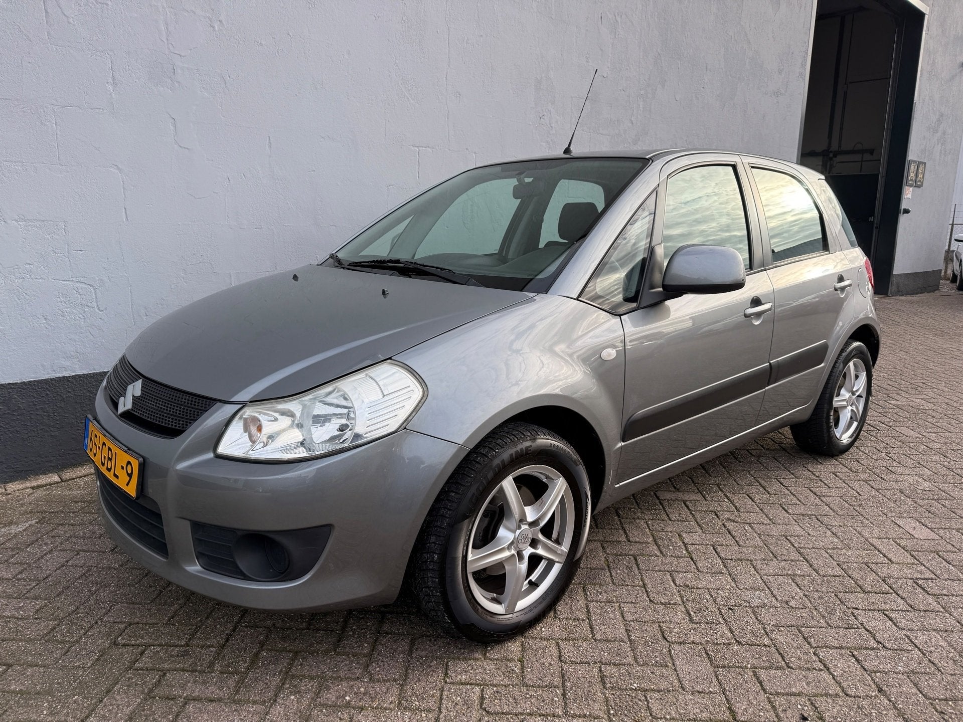 Suzuki SX4 1.6 Comfort - Trekhaak - Airco, Auto's, Gebruikt, 4 cilinders, 49 €/maand, Origineel Nederlands