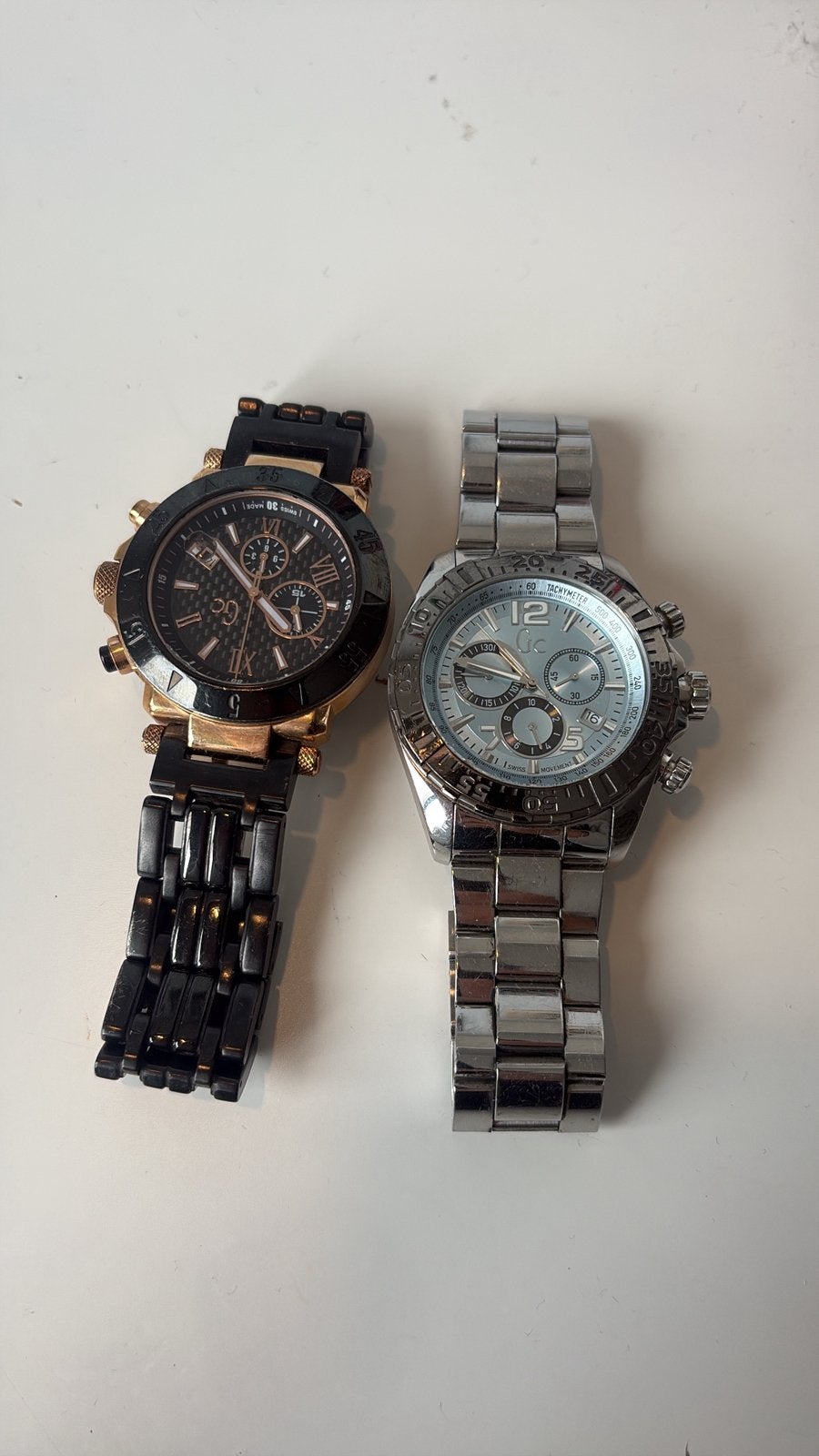 Twee horloges: zwart/goud en zilver, batterij leeg, Gebruikt, Staal, Polshorloge, Ophalen