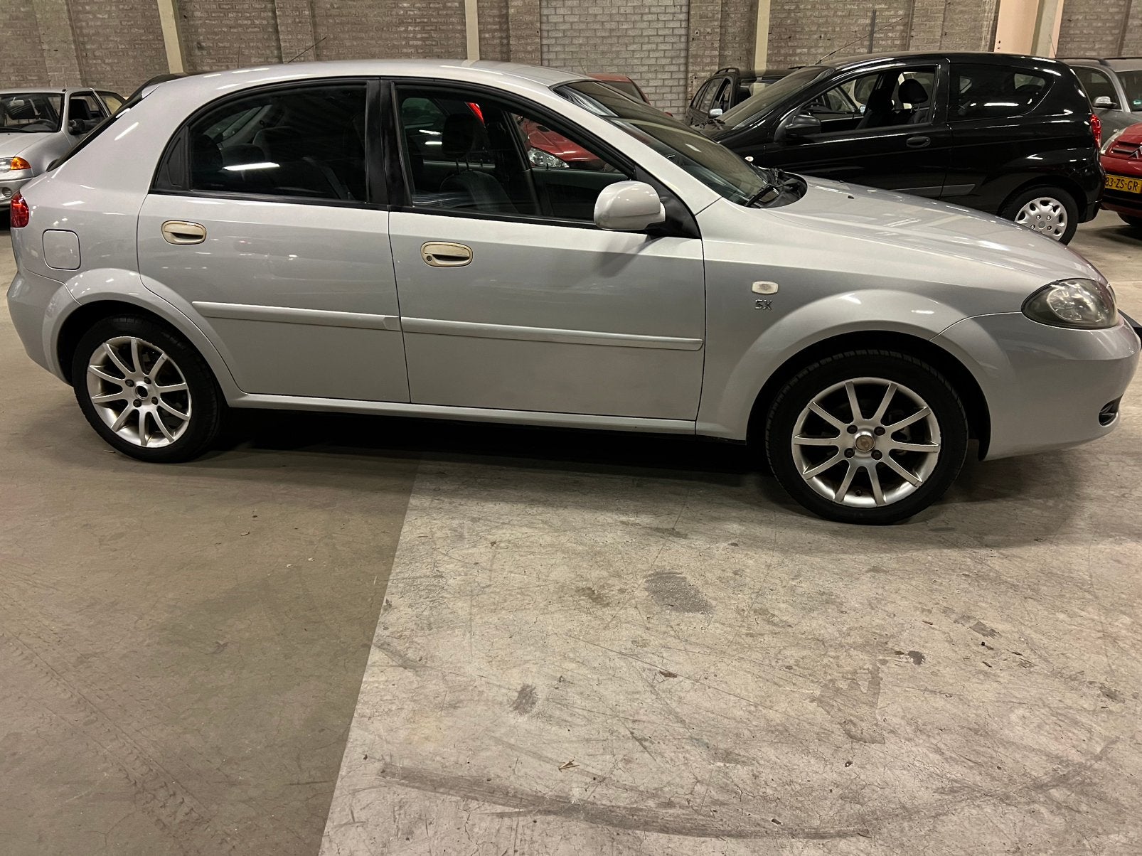 Daewoo Lacetti 1.6 HB 2004 Grijs km 224789, Auto's, Voorwielaandrijving, Lacetti, 4 cilinders, 610 kg