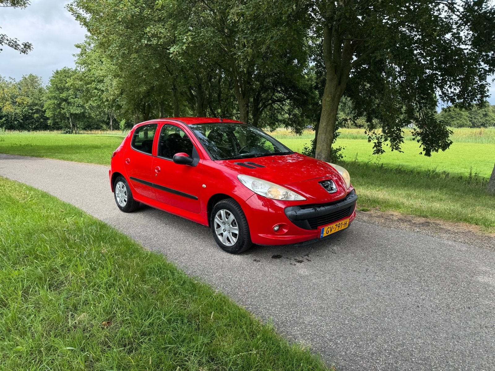 Zeer nette Peugeot 206+ 1.1 5D 2009 Rood, Auto's, Voorwielaandrijving, 206+, Stof, Handgeschakeld