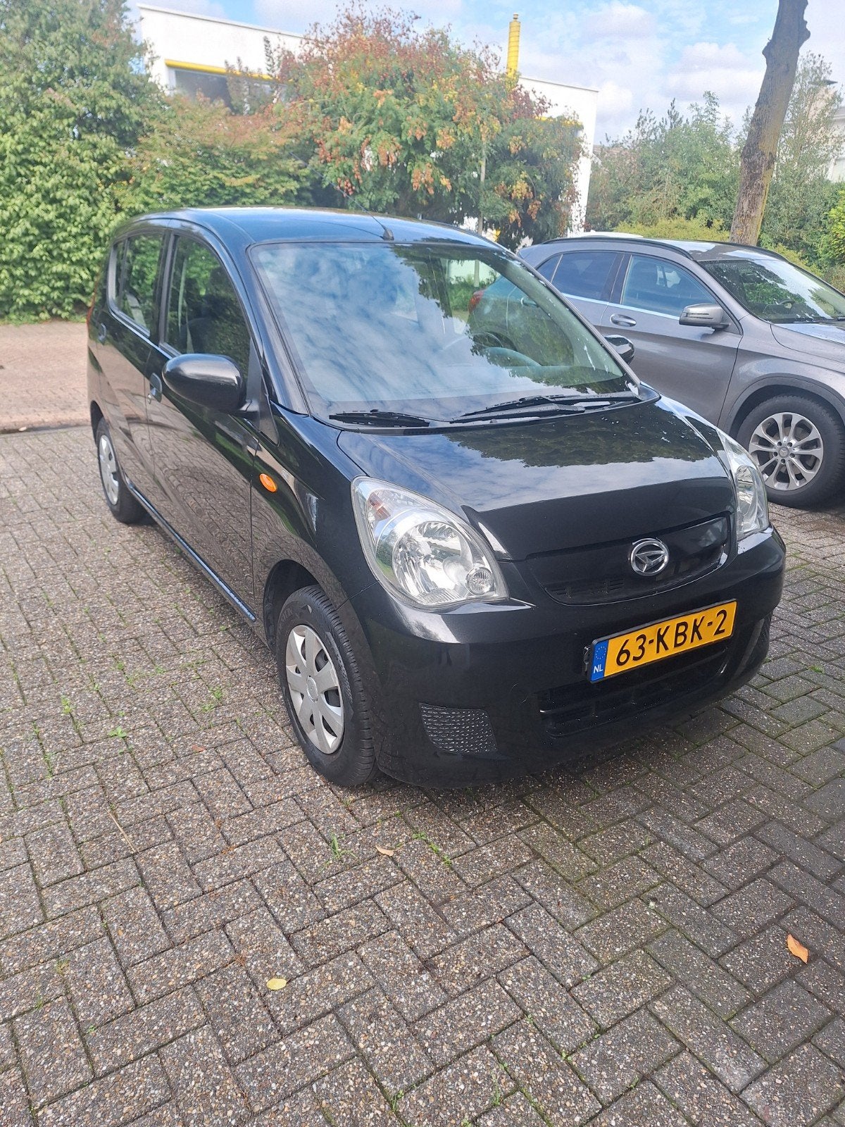 Daihatsu Cuore 1.0 5D 2009 Zwart airco met 64.517 km, Voorwielaandrijving, 600 kg, 18 €/maand, 4 stoelen