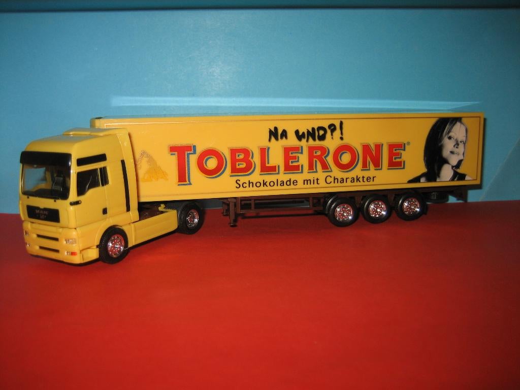 Toblerone  MAN  oplegger met FOTO  Herpa, Hobby en Vrije tijd, Modelauto's | 1:87, Ophalen of Verzenden, Zo goed als nieuw, Bus of Vrachtwagen