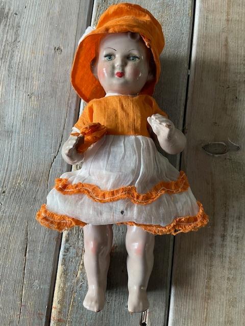 Antieke mamma pop met authentieke oranje kleding met hoedje, Ophalen