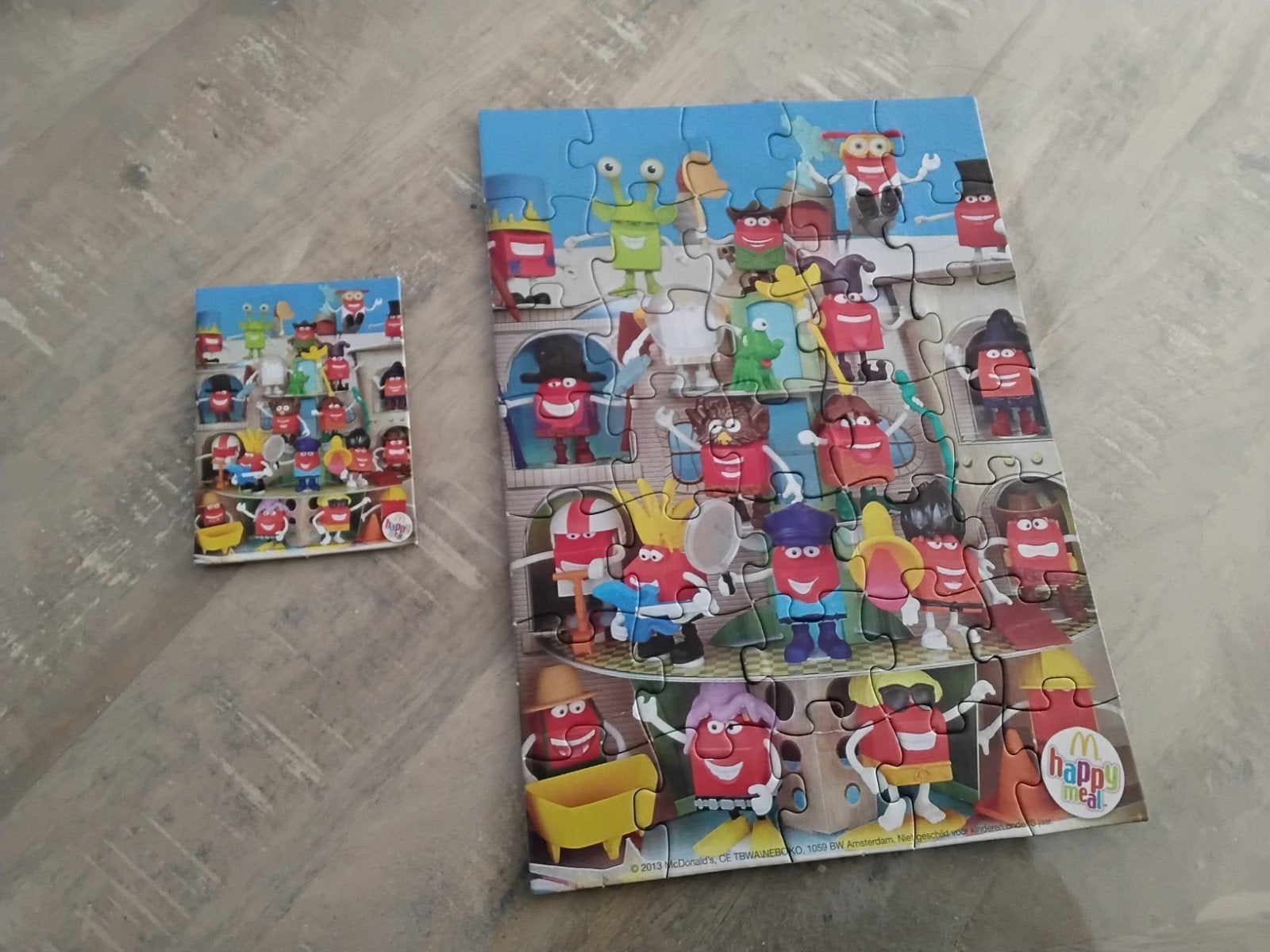 Happy meal puzzel in film blik bijna gratis, Ophalen, 10 tot 50 stukjes, Zo goed als nieuw