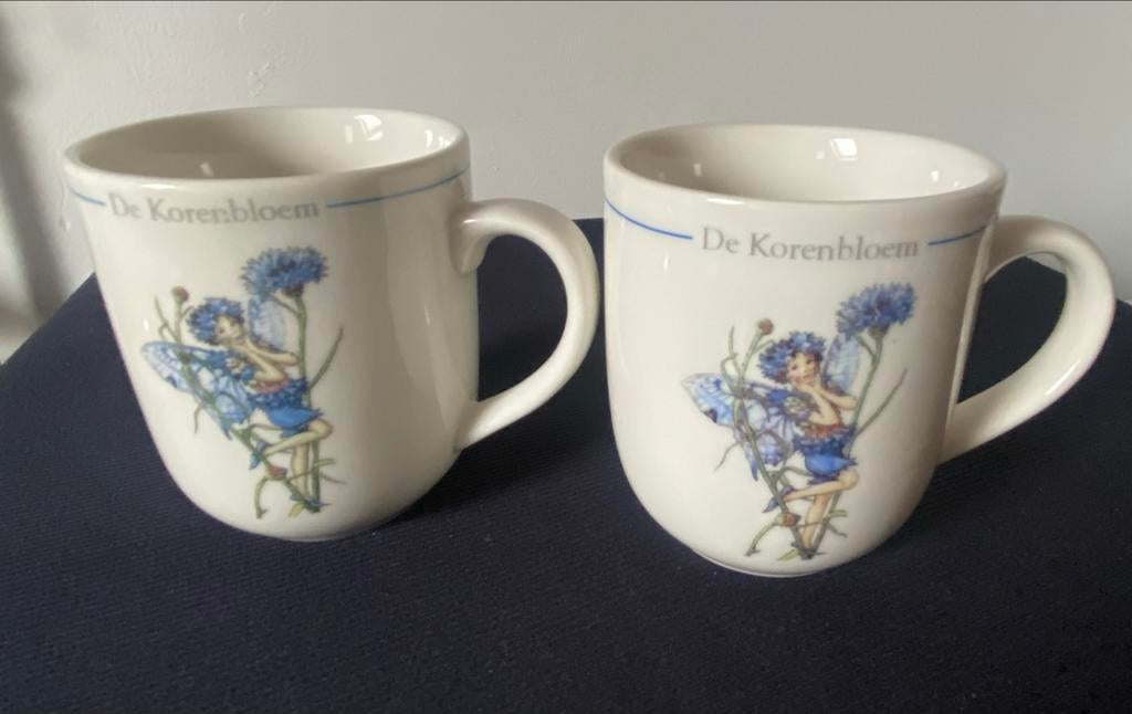 2 Mokken van Flower Fairies 'De Korenbloem'. Hoogte 9 cm., Overige materialen, Ophalen of Verzenden, Zo goed als nieuw, Overige stijlen