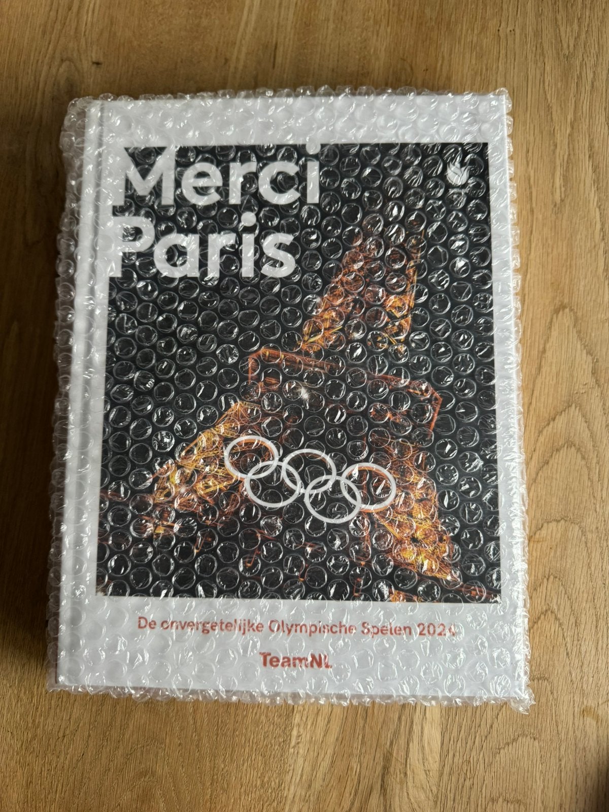 Boek Merci Paris TeamNL olympische spelen, Ophalen of Verzenden, Nieuw