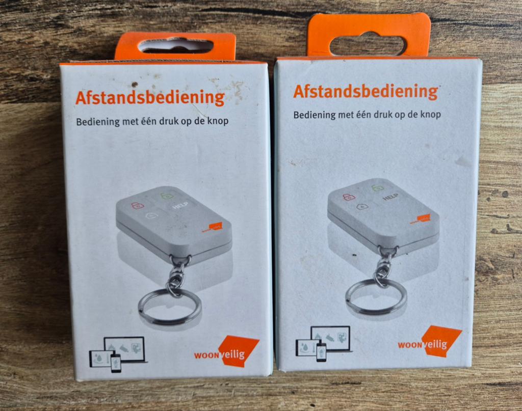 Woonveilig 2x Afstandsbediening met één druk op de knop, Ophalen of Verzenden, Nieuw, Origineel