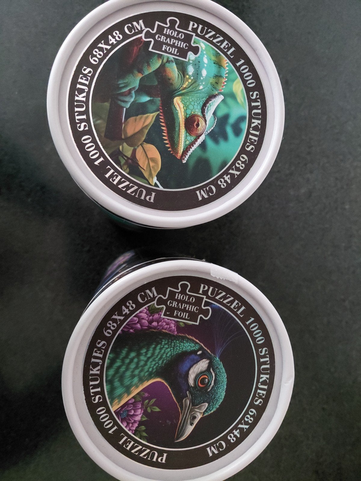 2 Puzzels, 1000 stukjes ,in ronde koker, Holo Graphic Foil., Ophalen of Verzenden, 500 t/m 1500 stukjes, Zo goed als nieuw