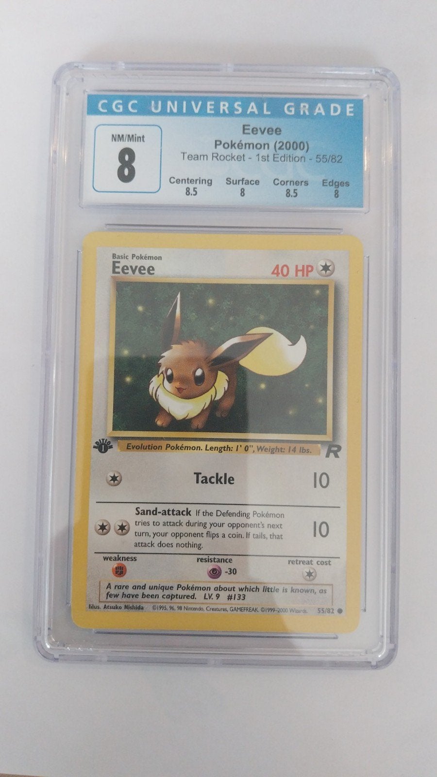 CGC 8 Eevee Pokémon (2000) Team Rocket 1st Edition, Hobby en Vrije tijd, Ophalen of Verzenden, Zo goed als nieuw, Losse kaart