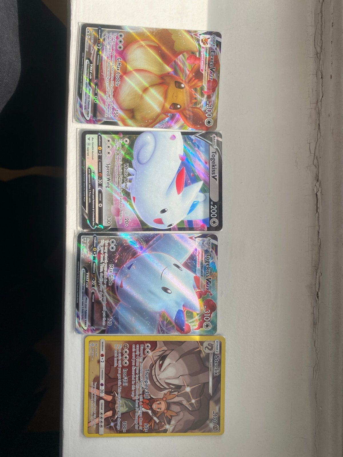 Pokémon V en VMAX kaarten (Eevee, Togekiss, Steelix), Ophalen of Verzenden, Gebruikt, Meerdere kaarten