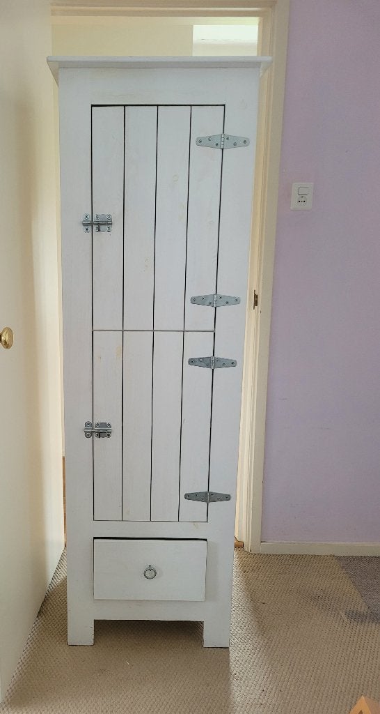 Witte kledingkast voor de babykamer met een lade en hangers