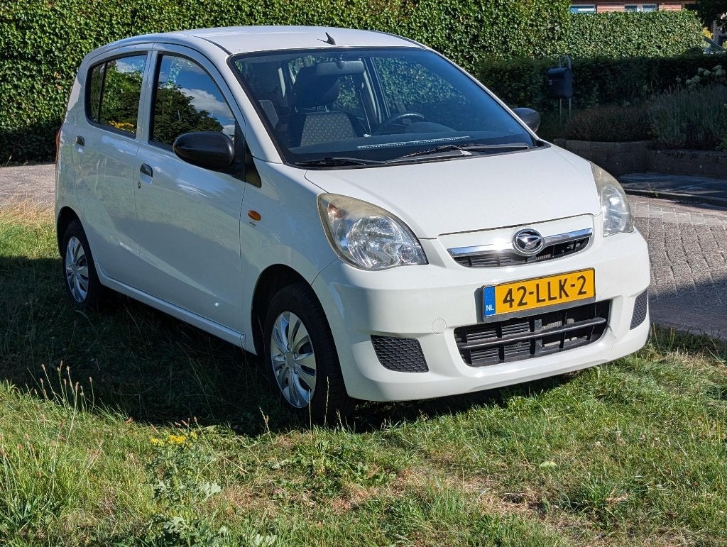 Daihatsu Cuore Clever 1.0 5D 2011 Wit, Auto's, Daihatsu, Voorwielaandrijving, Stof, 600 kg, Zwart