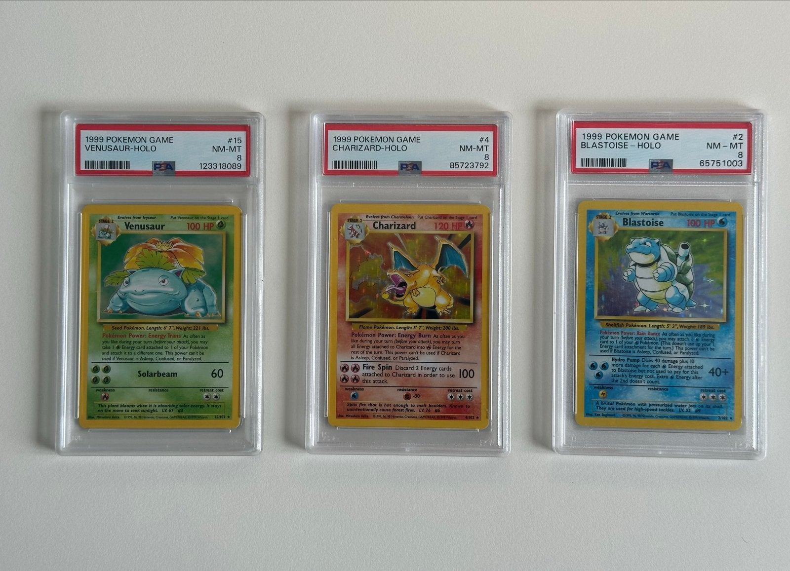 PSA8 Base Set Venusaur, Charizard & Blastoise Set, Ophalen, Zo goed als nieuw, Meerdere kaarten, Foil